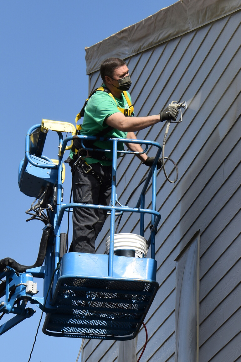 Man painting building.