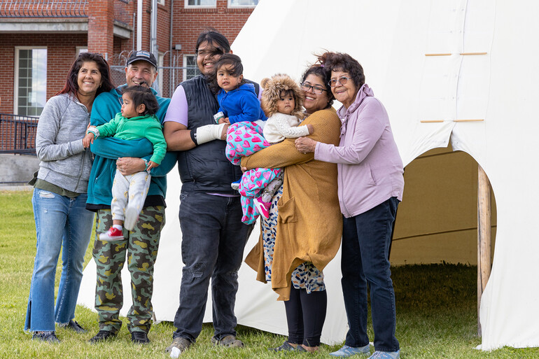 Family in front of tipi