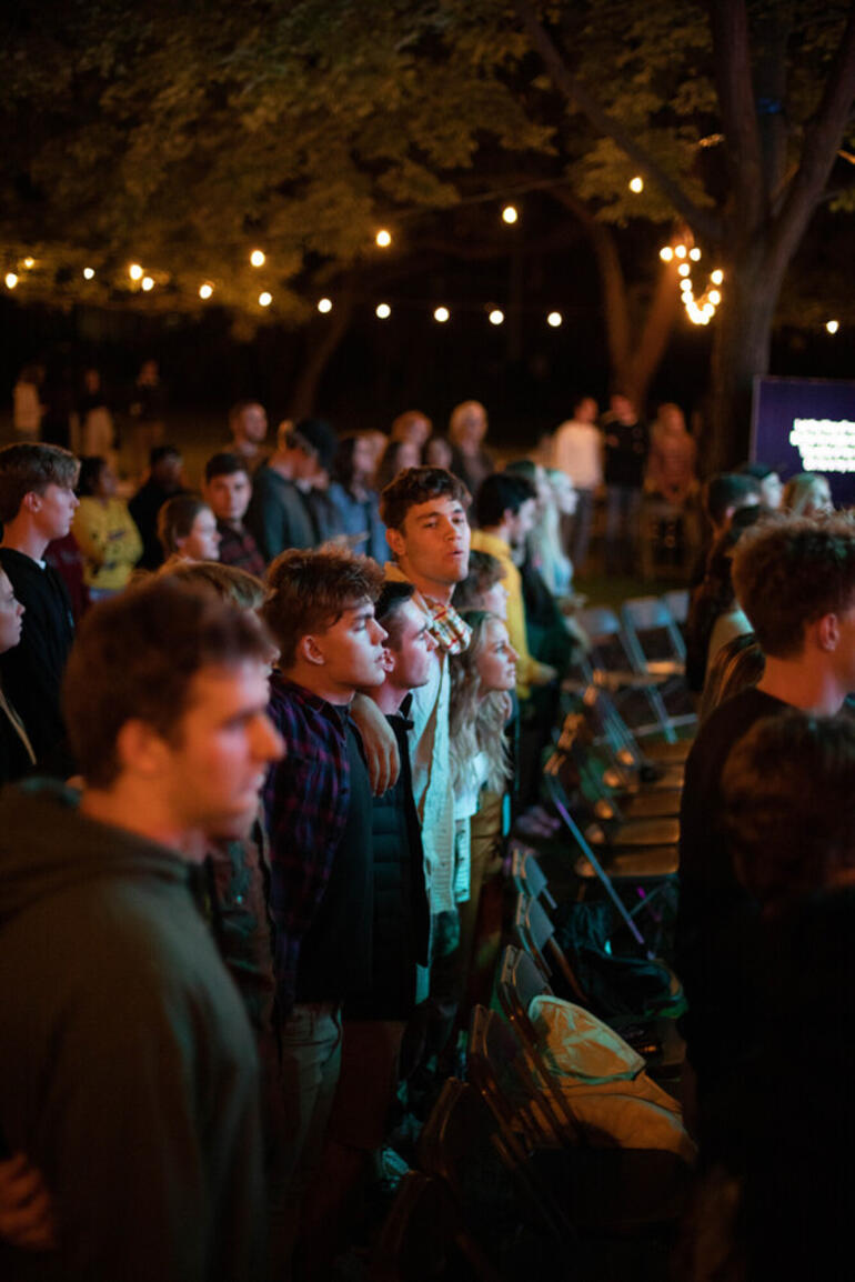 Students gather at outside church