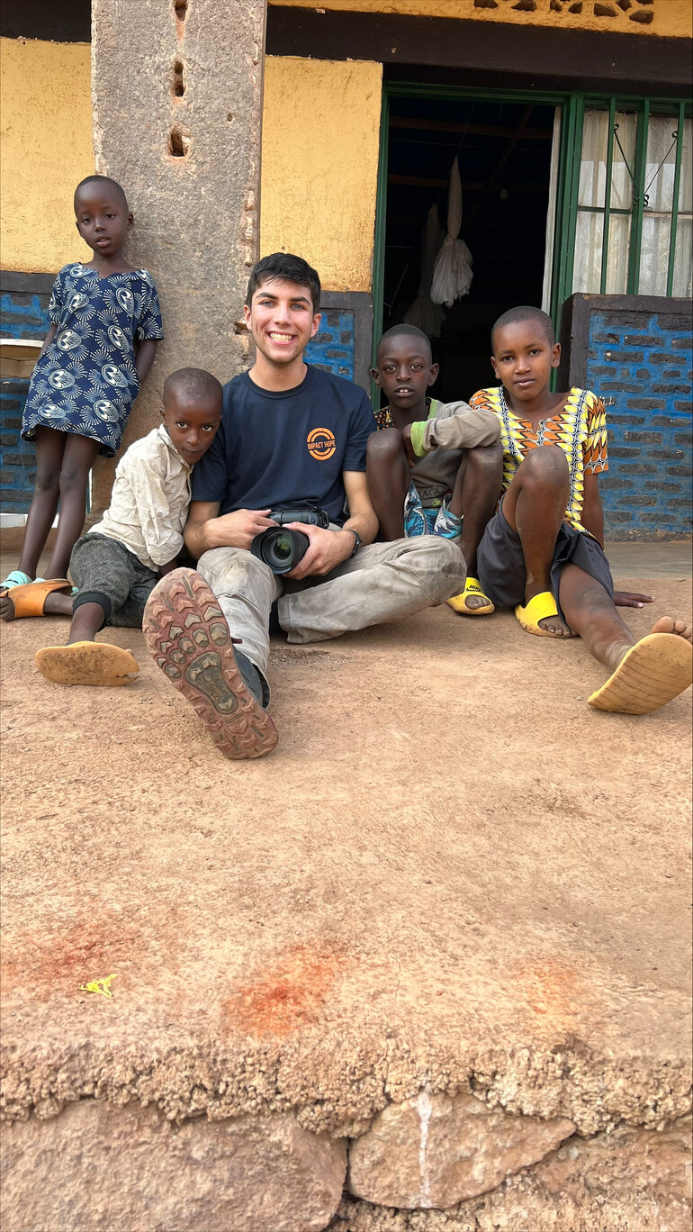 Tyler Parker visits with refugee children in Rwanda.