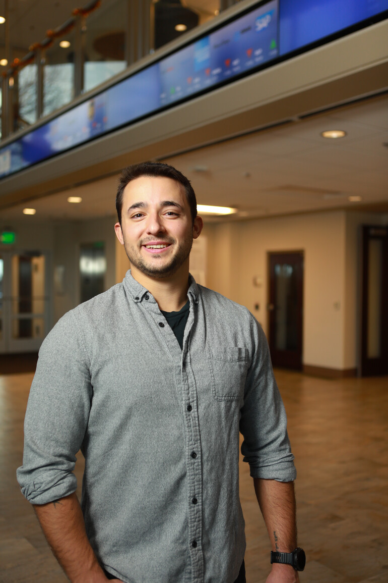 Portrait of Garret Thorn in front of stock ticker.