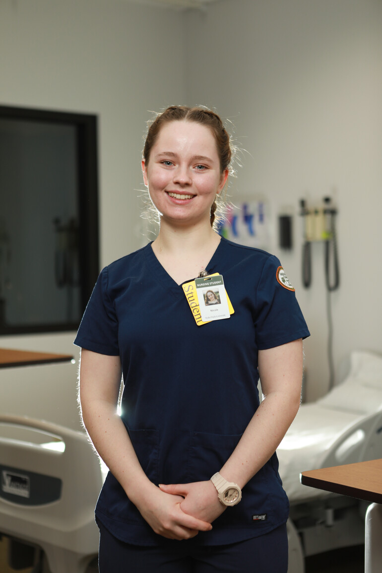 Portrait of Nicole Price in hospital simulation lab.