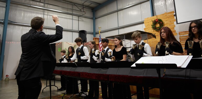 students playing handbells being directed