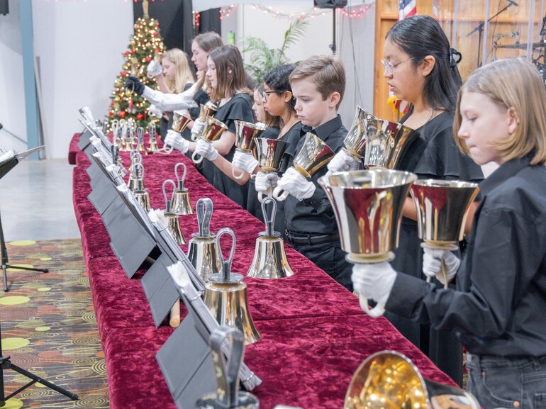 Students play handbells for a concert