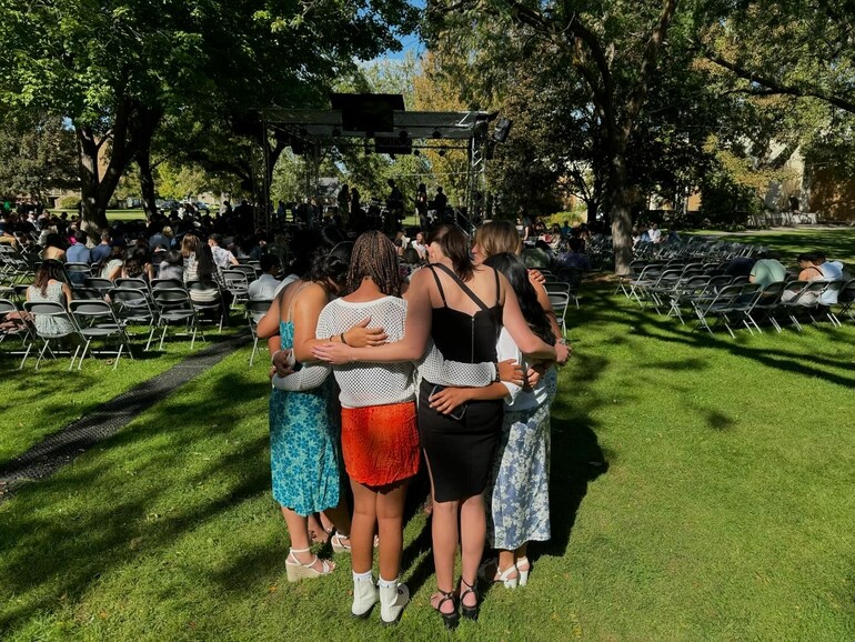 Students gather in prayer outside