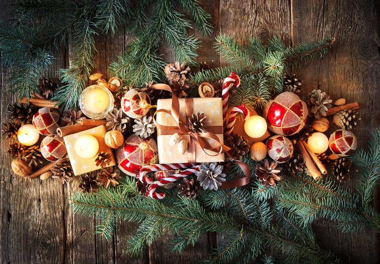 Christmas Composition Top View. Fir Tree Toys with Burning Candles, Boxes, Balls, Pine Cones, Walnuts, Branches of Spruce on Wooden Background