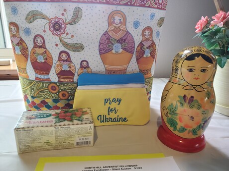 A silent auction display encouraging people to pray for Ukraine.