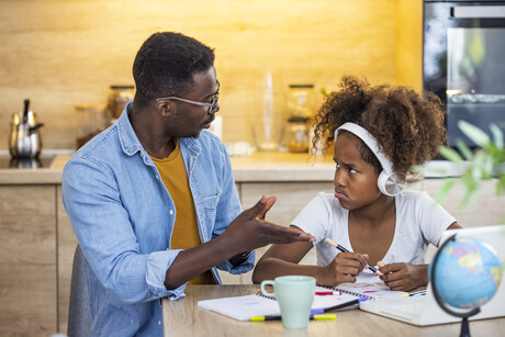 Father talking to pouting daughter.