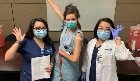 Karen Ong and her mother administer a vaccine.