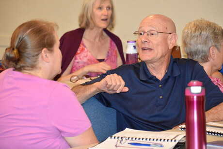 Norval Rios shares with another attendee.