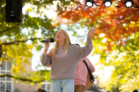 Student sings on outdoor stage