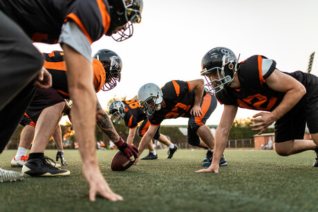 Young Men Playing American Football Game On Sports Training at Stadium