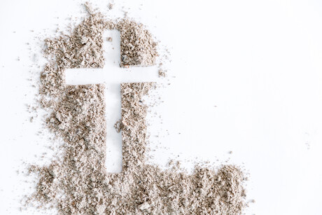 Christian cross or crucifix drawing in ash, dust or sand as symbol of religion, sacrifice, redemption, Jesus Christ, ash wednesday, lent, Good Friday, Easter with Church is devoted to fasting