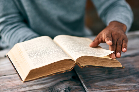 Cropped shot of an unrecognizable man reading a book