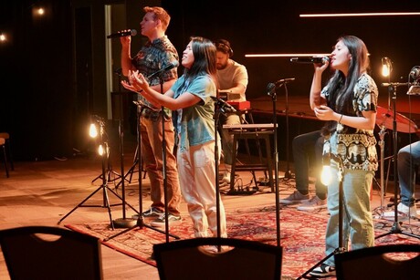 Three students sing for church.