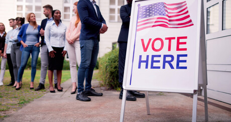 Diverse People At Voting Booth. Vote Here Elections Sign