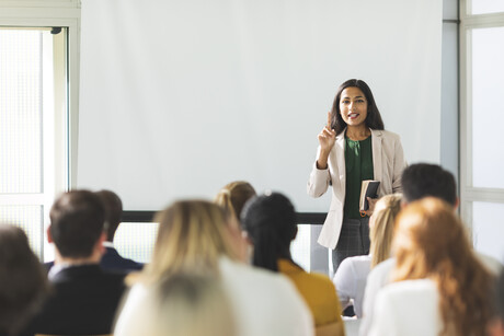 A woman speaks to a group of people