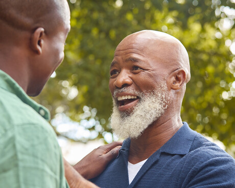 Father and son laughing outdoors