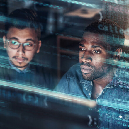 Two men looking at a computer.