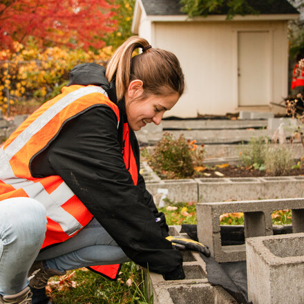 Student constructs a garden bed.