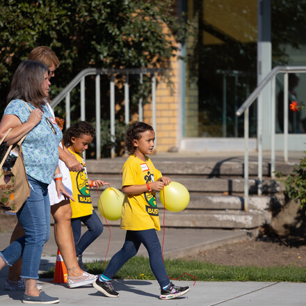 Children carry balloons on WWU campus