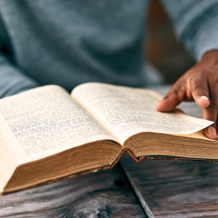 Cropped shot of an unrecognizable man reading a book