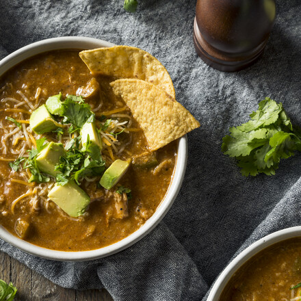 Spicy Homemade Tortilla Soup with Cheese Cilantro and Lime