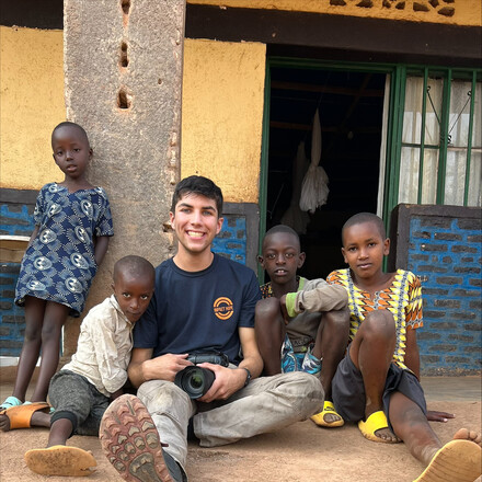 Tyler Parker visits with refugee children in Rwanda.