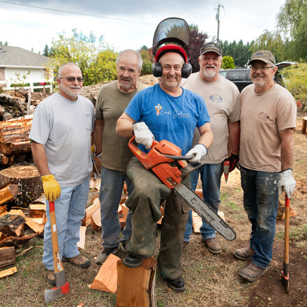 group of men with wood cutting tools