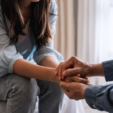 Young man comforting and supporting a sad woman who is in serious trouble at home, Consolation and encouragement concept