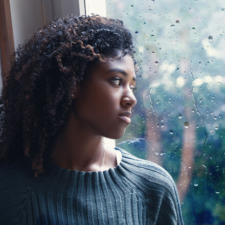 Black woman feeling depression symptoms alone at home