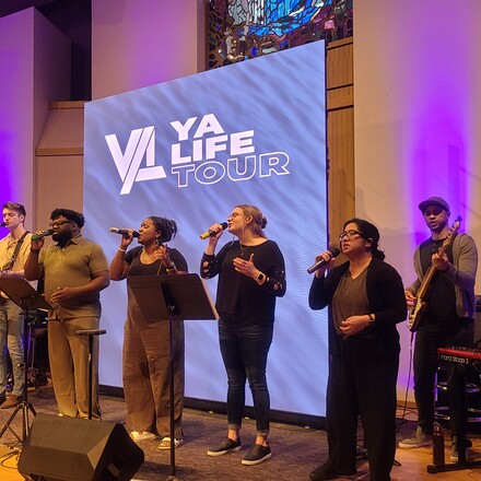 young adults singing on a stage