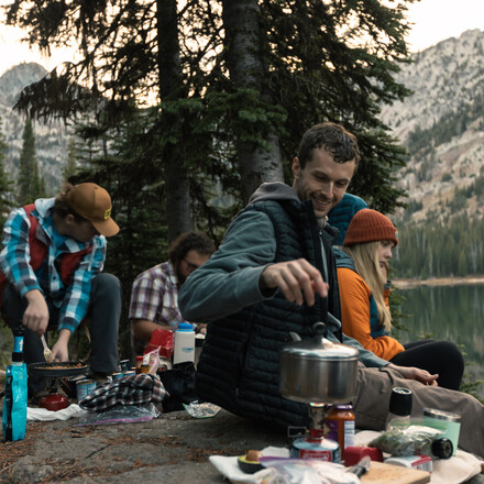 Students cook over campfire
