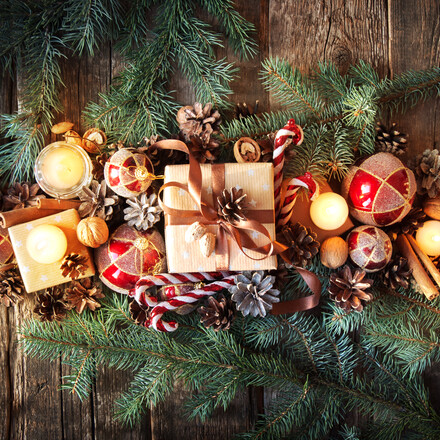Christmas Composition Top View. Fir Tree Toys with Burning Candles, Boxes, Balls, Pine Cones, Walnuts, Branches of Spruce on Wooden Background