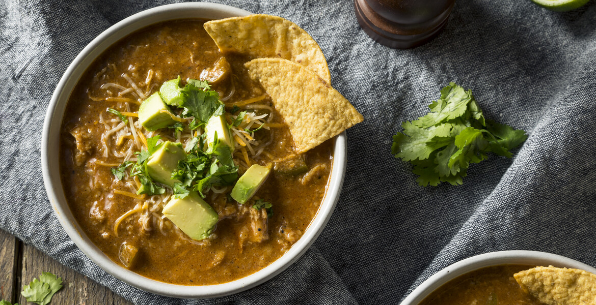 Spicy Homemade Tortilla Soup with Cheese Cilantro and Lime