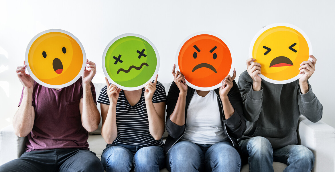 Diverse people holding emoticon