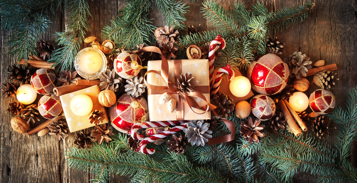Christmas Composition Top View. Fir Tree Toys with Burning Candles, Boxes, Balls, Pine Cones, Walnuts, Branches of Spruce on Wooden Background